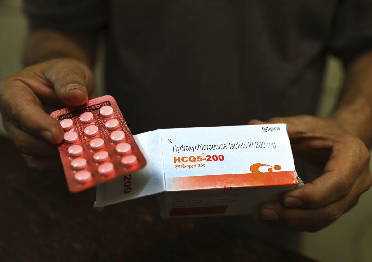 A chemist displays hydroxychloroquine tablets in New Delhi. 
