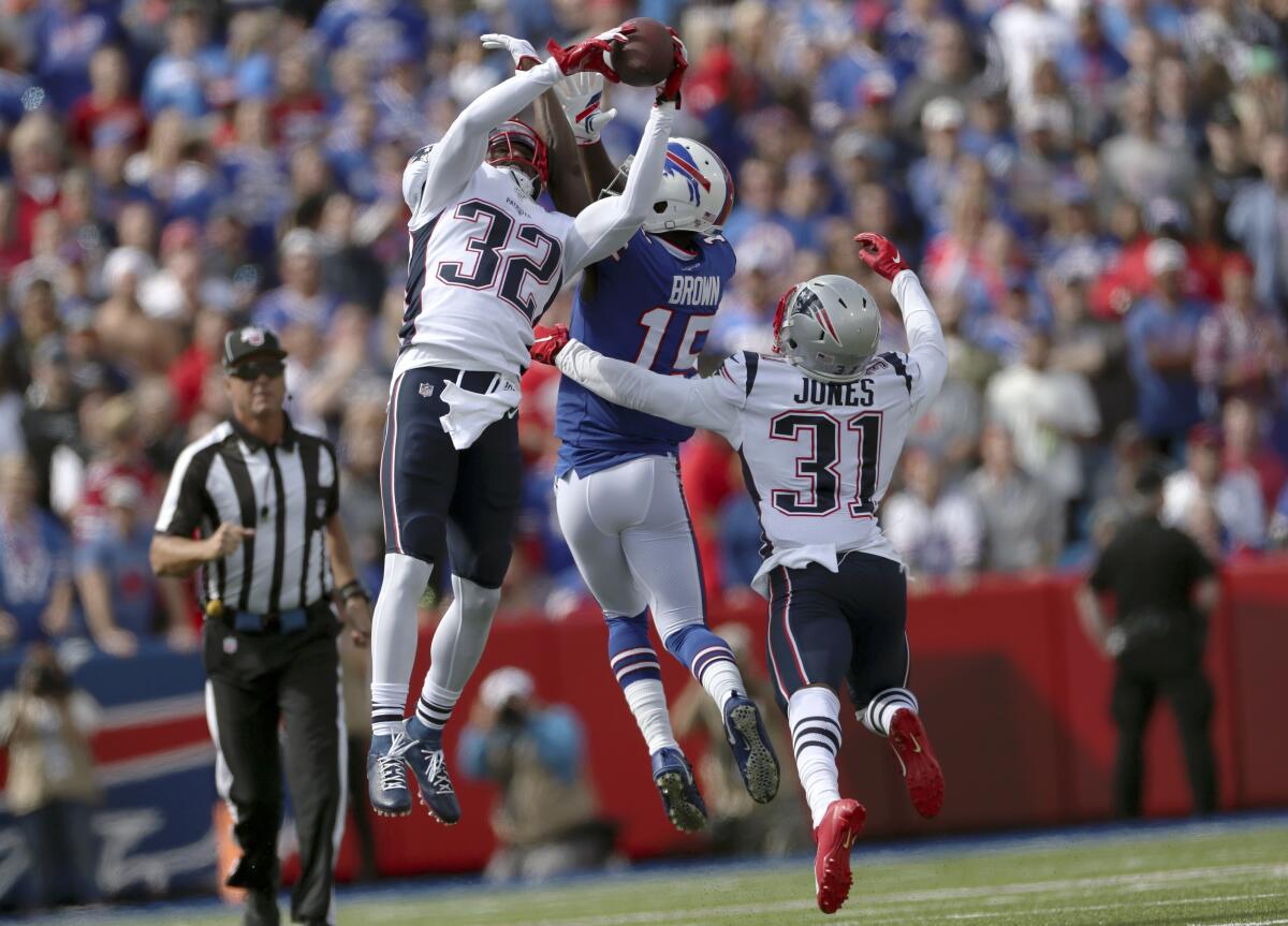New England Patriots safety Devin McCourty (32) intercepts a pass intended for Buffalo Bills wide receiver John Brown (15) in the first half in Orchard Park, N.Y. on Sept. 29.