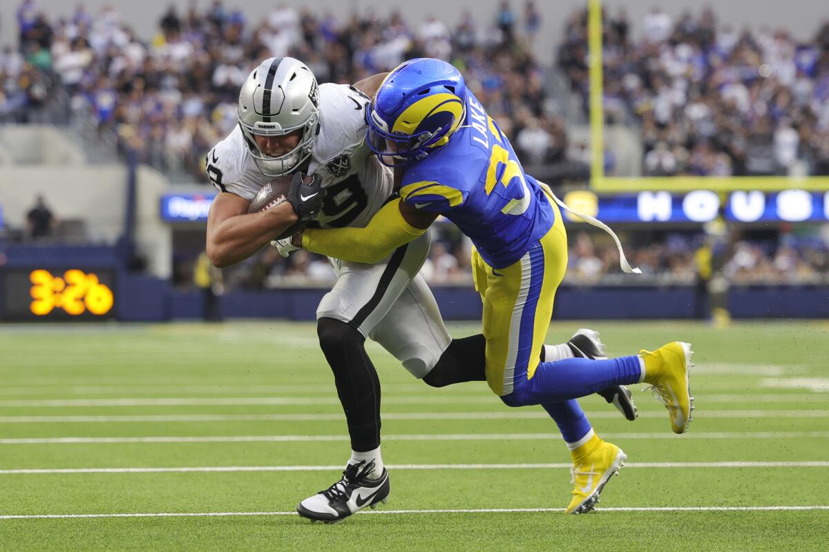 Rams safety Quentin Lake tackles Las Vegas Raiders tight end Brock Bowers.