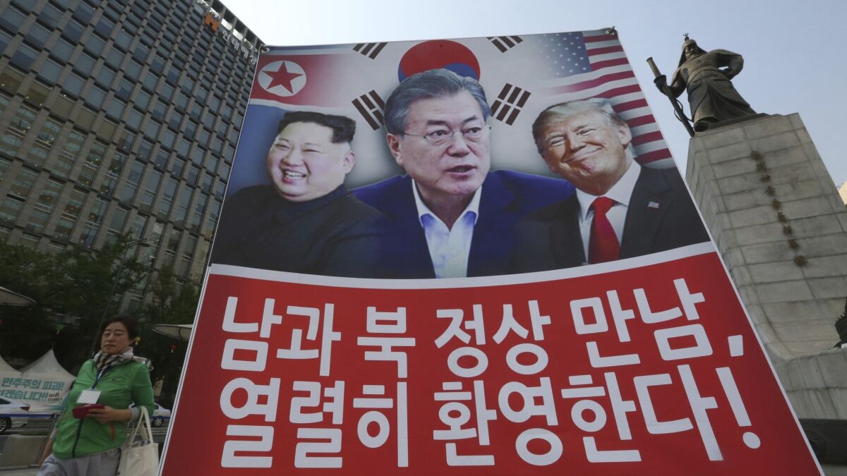 A banner showing North Korean leader Kim Jong Un, left, South Korean President Moon Jae-in and President Trump erected in Seoul to support the summit between the two Koreas on April 27.