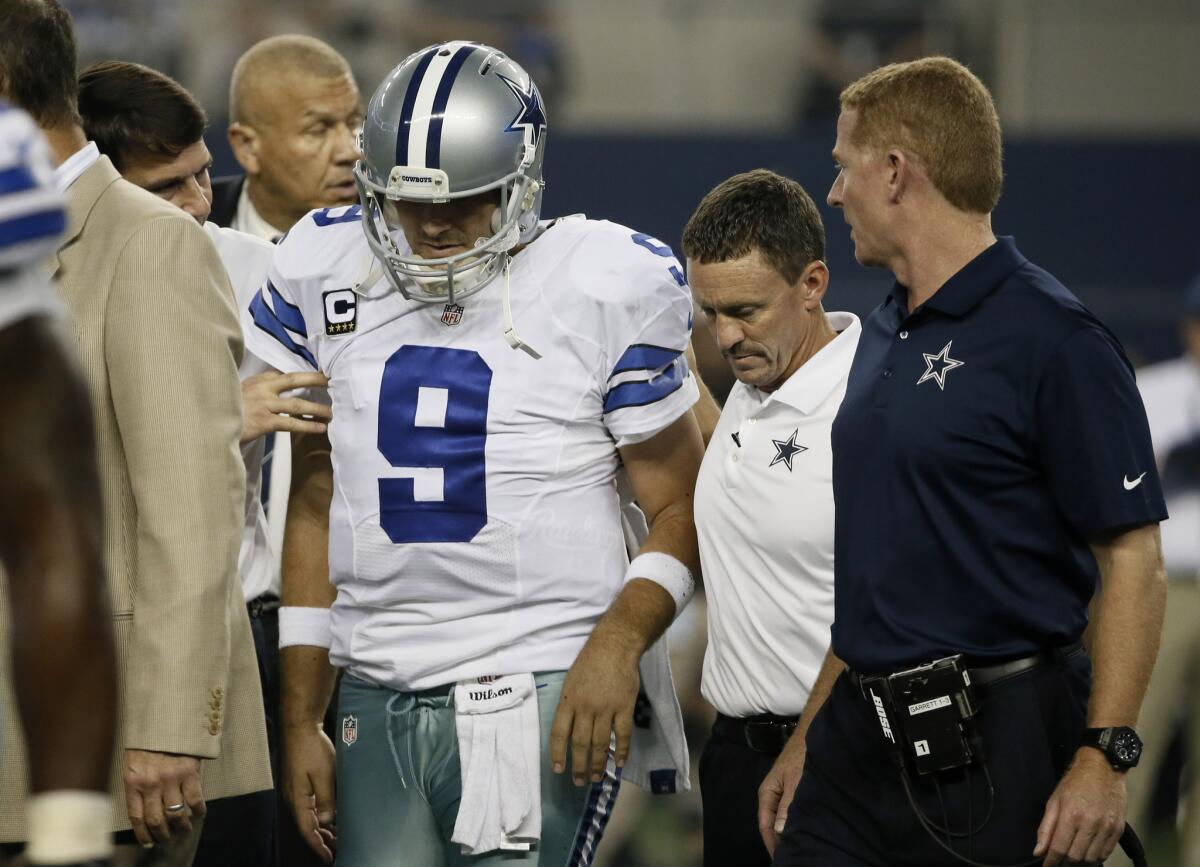 Dallas quarterback Tony Romo is helped off the field Monday against Washington.