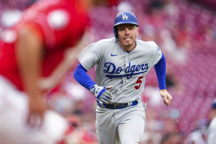 Los Angeles Dodgers' Freddie Freeman heads home to score on a sacrifice fly by J.D. Martinez during the first inning of the team's baseball game against the Cincinnati Reds in Cincinnati, Tuesday, June 6, 2023. (AP Photo/Aaron Doster)