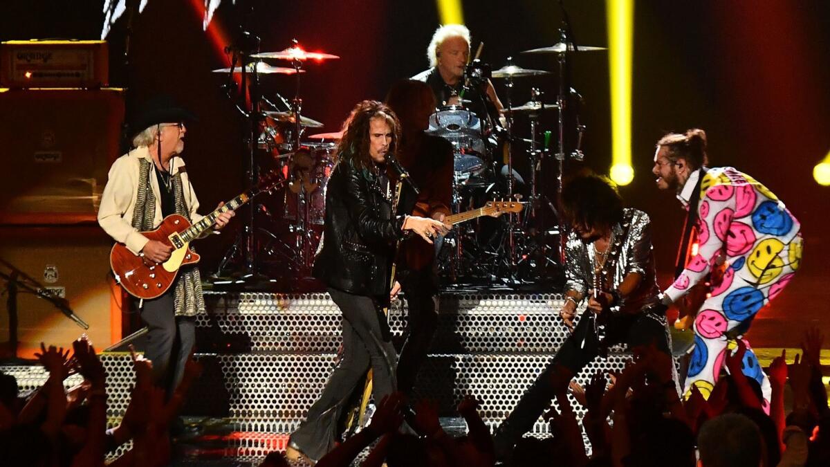 Post Malone, right, performs with Aerosmith.