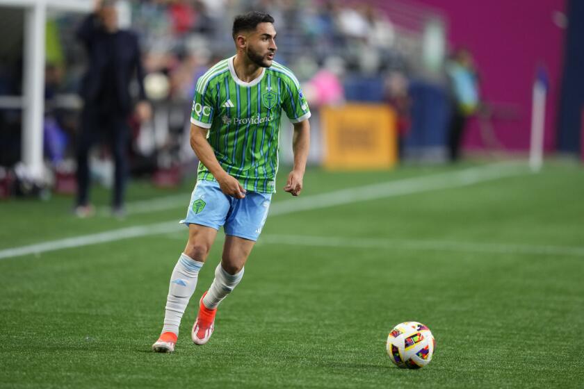 Seattle Sounders midfielder Cristian Roldan moves the ball against against the Vancouver Whitecaps during the first half of an MLS soccer match Saturday, May 18, 2024, in Seattle. (AP Photo/Lindsey Wasson)