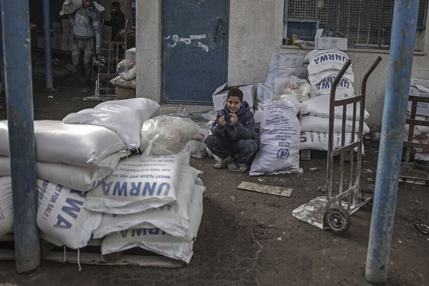 Mandatory Credit: Photo by MOHAMMED SABER/EPA-EFE/REX/Shutterstock (9324431e) A Palestinian refugee boy sits near his family relief aid at the United Nation food distribution center in al Shateaa refugee camp in the northern Gaza city, 15 January 2018 (issued 17 January 2018). Media report that the US President Donald J. Trump had vowed to freeze about 125 million US dollar of aid for the United Nation Relief and Works Agency (UNRWA) for Palestinian Refugees. The US ambassador to the United Nation (UN) Nikki Haley was quoted as saying that Trump did not want to add or stop funding until the Palestinians agree to return to the negotiation table. Following the 1948 Arab-Israel conflict, UNRWA was established by the United Nation General Assembly Resoluation 302 (IV) in 1949 to carry out direct relief and works programs for Palestinian refugees from May 1950 on. until today, some five million Palestinian refugees are eligible for their services, UNRWA says on their website. UNRWA offices in Gaza, Gaza Strip, --- - 15 Jan 2018 ** Usable by LA, CT and MoD ONLY **