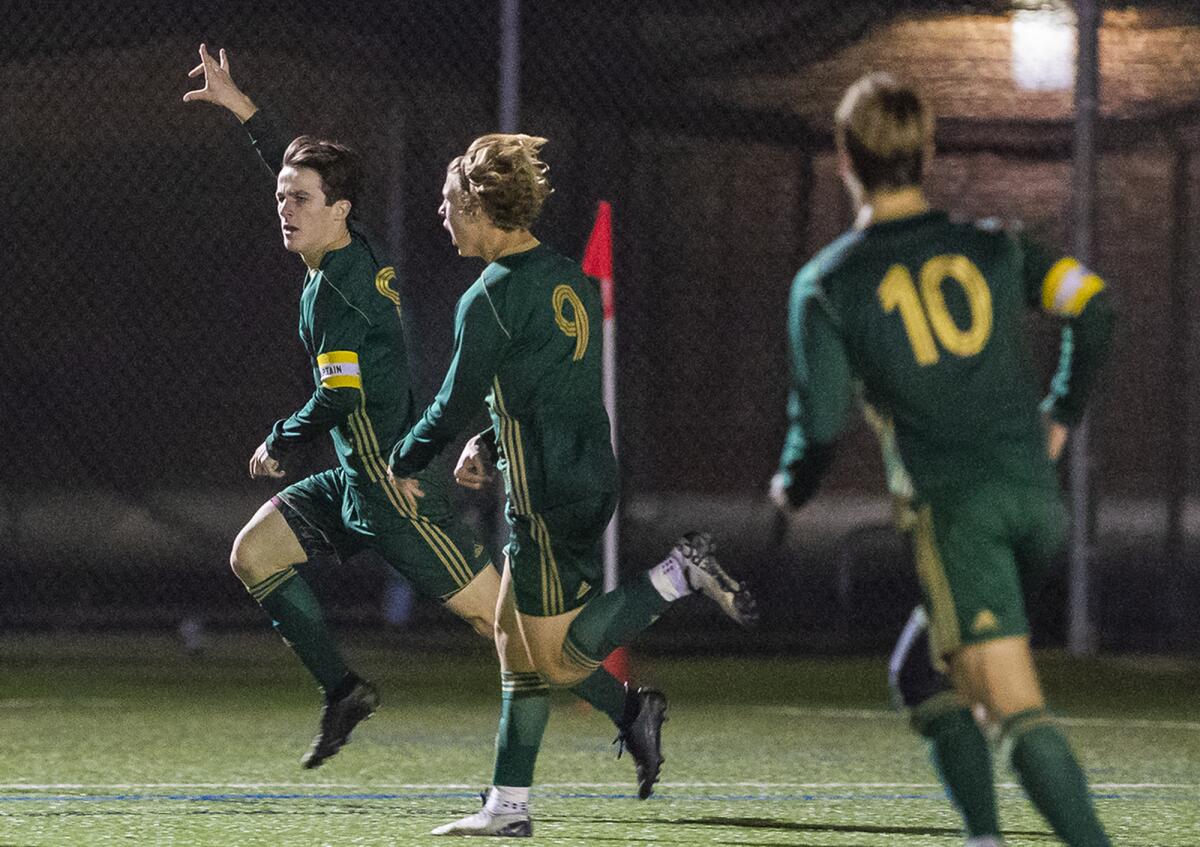 Edison's Nick Morrell, left, celebrates his goal in the 73rd minute with Cole Kennedy (9) and Kai Peterson (10) in a Surf League match against Corona del Mar on Friday.