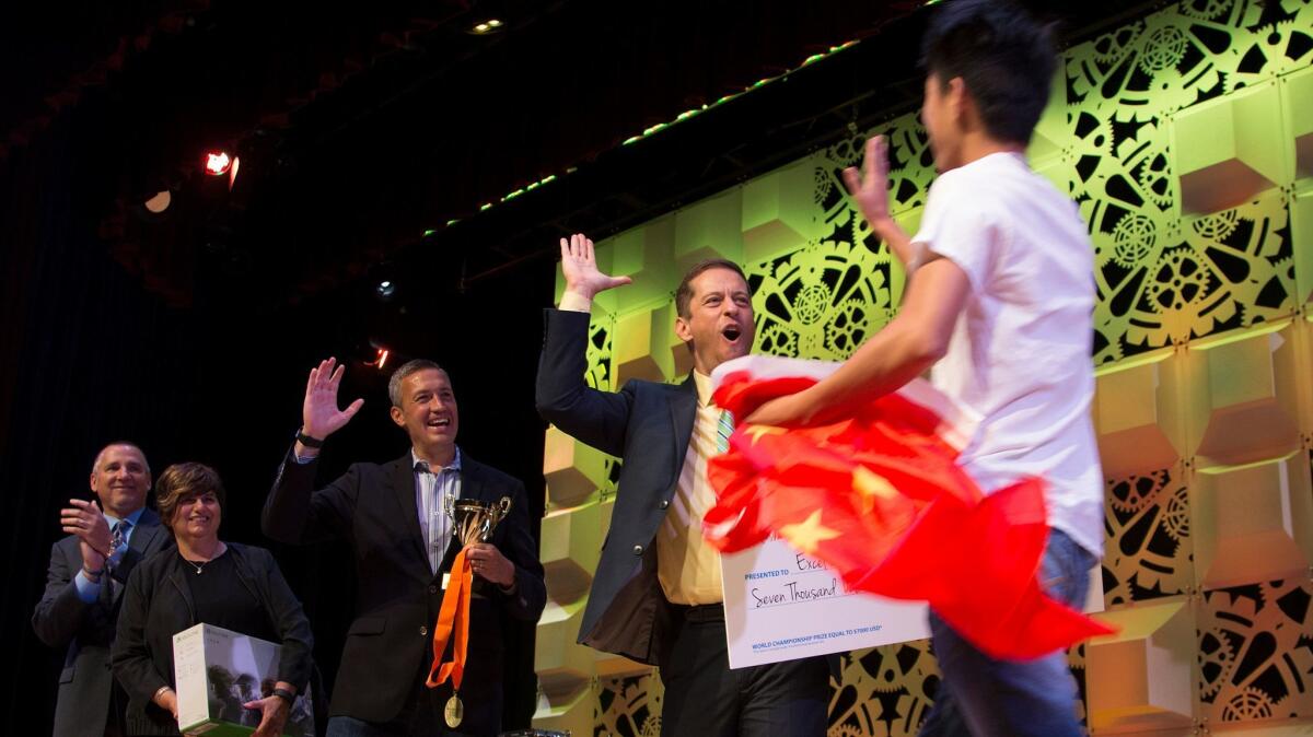JiaXi Dai of China gets a high-five from Aaron Osmond, general manager at Certiport, after being named Excel 2013 champion.