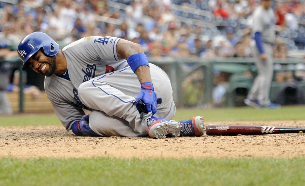Dodgers outfielder Matt Kemp reacts after spraining his ankle against the Washington Nationals in July. Kemp experienced tightness in his right hamstring Friday while running bases at the team's minor league facility.