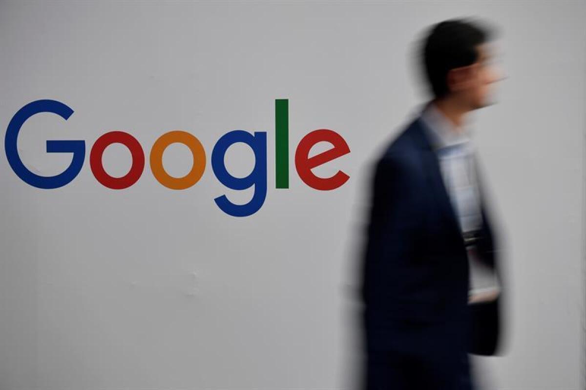 A man passes by a Google logo during the Vivatech startups and innovation fair, in Paris, France. EPA/Julien de Rosa/File