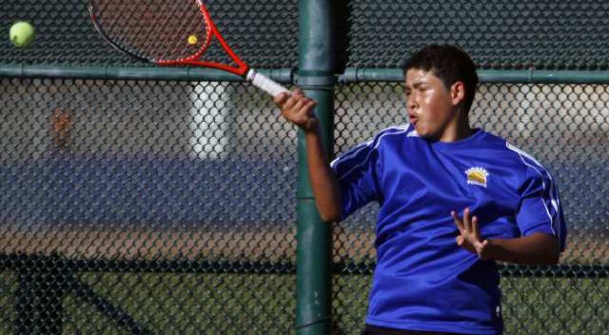 Burbank's Kevin Orellana plays against Artiom Ambatsoumian during a singles match at Burbank High.