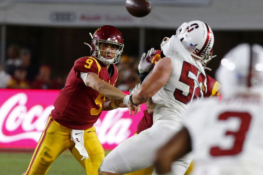 LOS ANGELES, CALIF. - SEP. 7, 2019. USC quarterback Kedon Slovis throws a pass downfield against Stafnford in the fourth quarter at the L.A. Memorial Coliseum on Saturday night, Sep. 7, 2019. (Luis Sinco/Los Angeles Times)