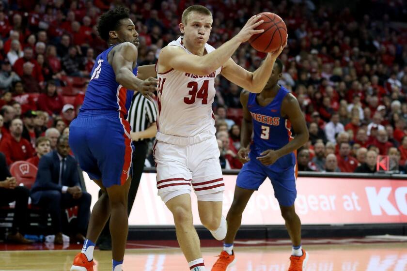 MADISON, WISCONSIN - DECEMBER 13: Brad Davison #34 of the Wisconsin Badgers dribbles the ball while being guarded by Jaquan Dotson #11 of the Savannah State Tigers in the first half at the Kohl Center on December 13, 2018 in Madison, Wisconsin. (Photo by Dylan Buell/Getty Images) ** OUTS - ELSENT, FPG, CM - OUTS * NM, PH, VA if sourced by CT, LA or MoD **