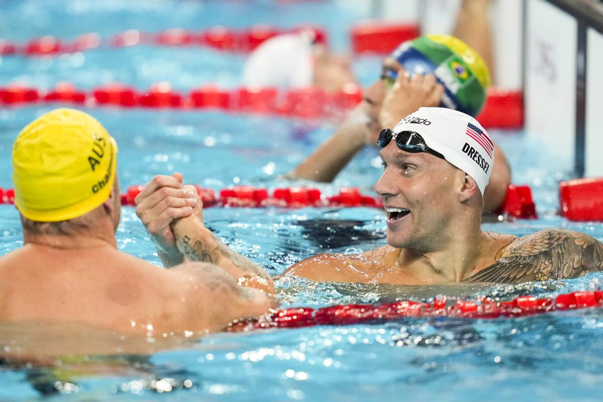 American Caeleb Dressel shakes hands with Australia's Kyle Chalmers after winning the 4x100 meter freestyle relay