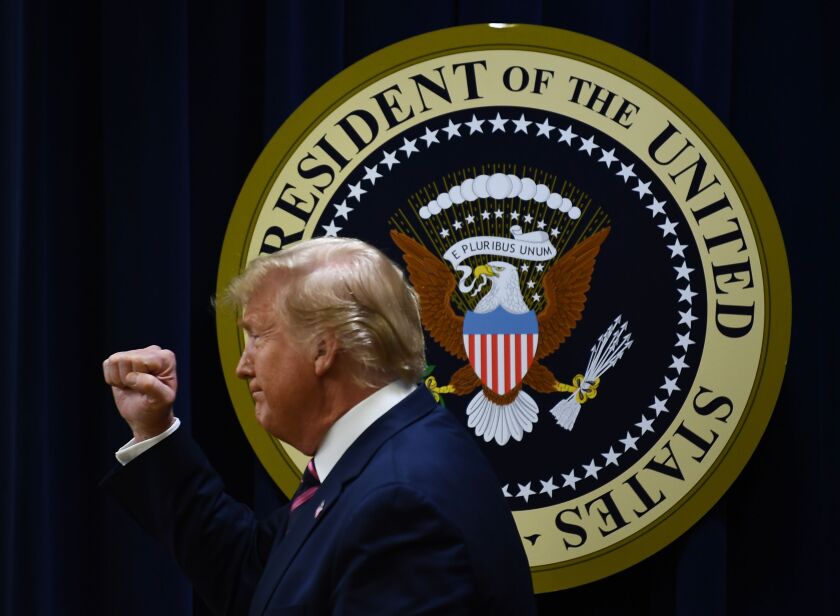 President Trump raises his fist at a White House event Dec. 19, the day after he was impeached by the House of Representatives.