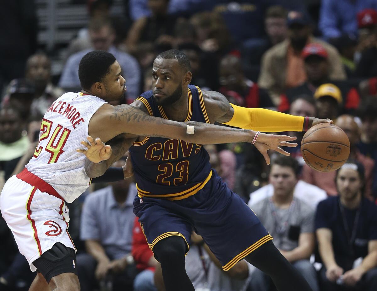 Cavaliers forward LeBron James (23) works against Hawks forward Kent Bazemore (24) during the first half of a game on Apr. 1.