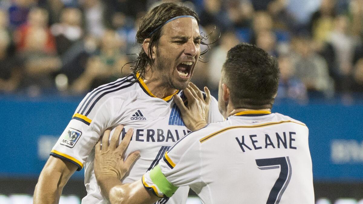Galaxy forward Alan Gordon, left, celebrates with teammate Robbie Keane after scoring against Montreal on Sept. 10, 2014.