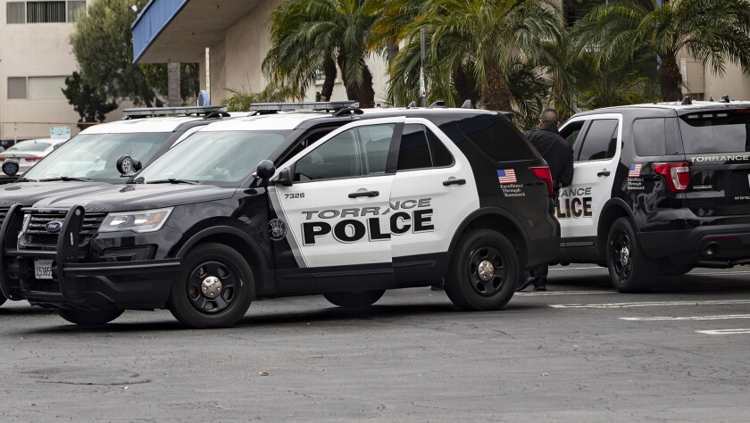 Torrance police stand guard outside the Gable House Bowl