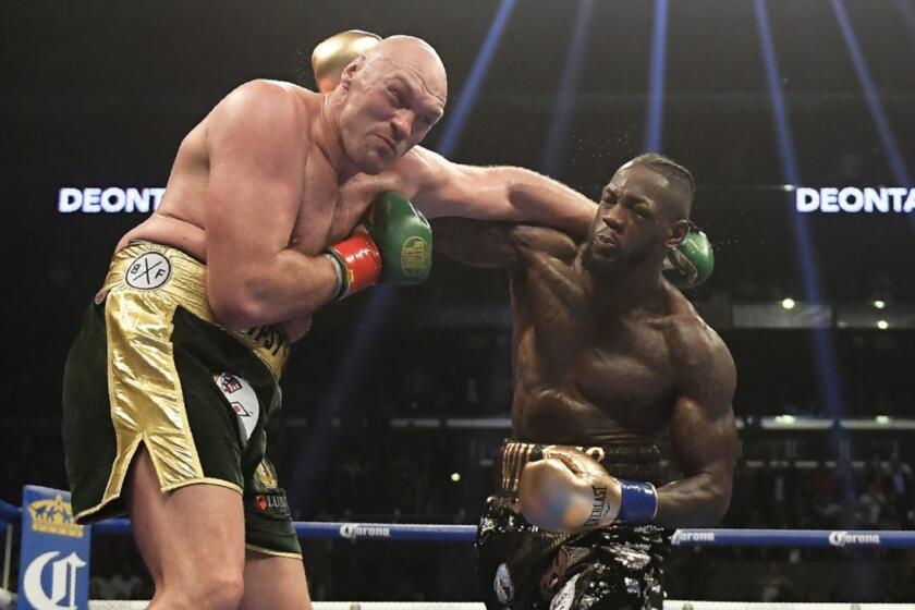 Deontay Wilder, right, connects with Tyson Fury, of England, during a WBC heavyweight championship boxing match, Saturday, Dec. 1, 2018, in Los Angeles. (AP Photo/Mark J. Terrill)