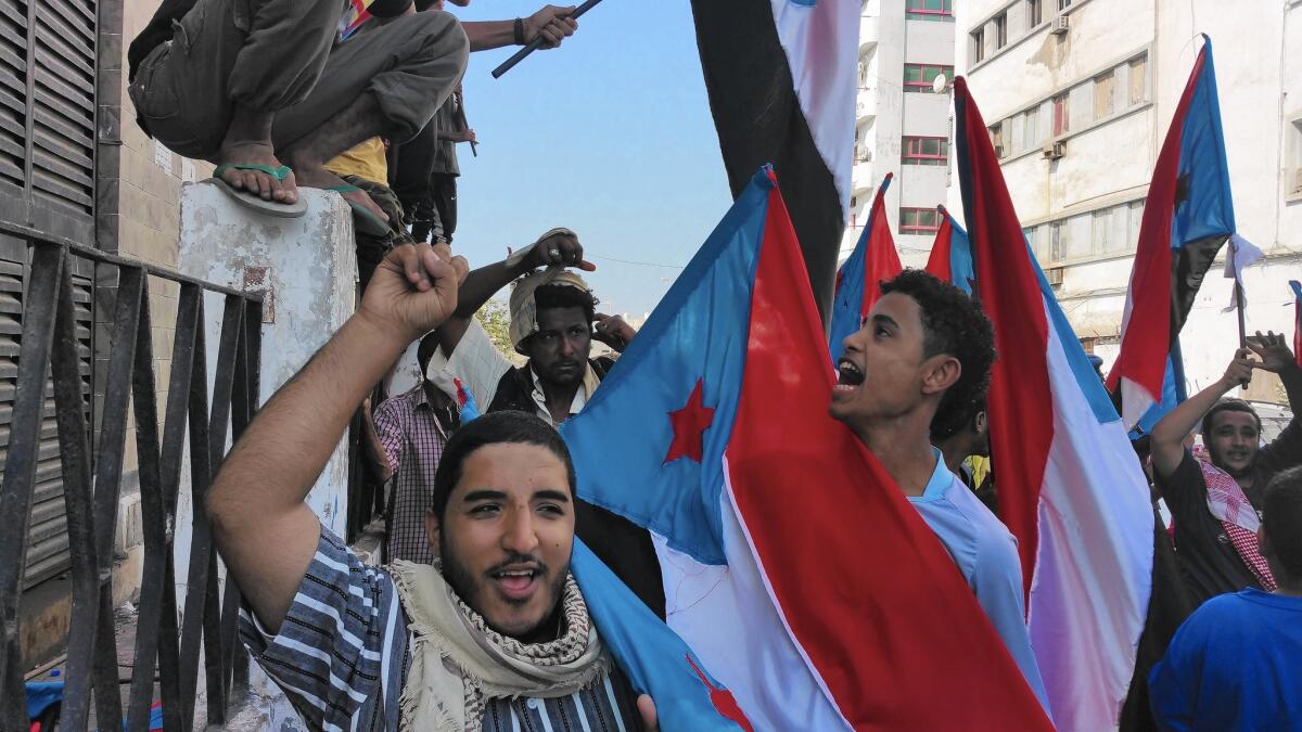 Demonstrators in the port city of Aden carry the flag of southern Yemen. Those who support breaking away from northern Yemen marched in Aden's Tawahi district.