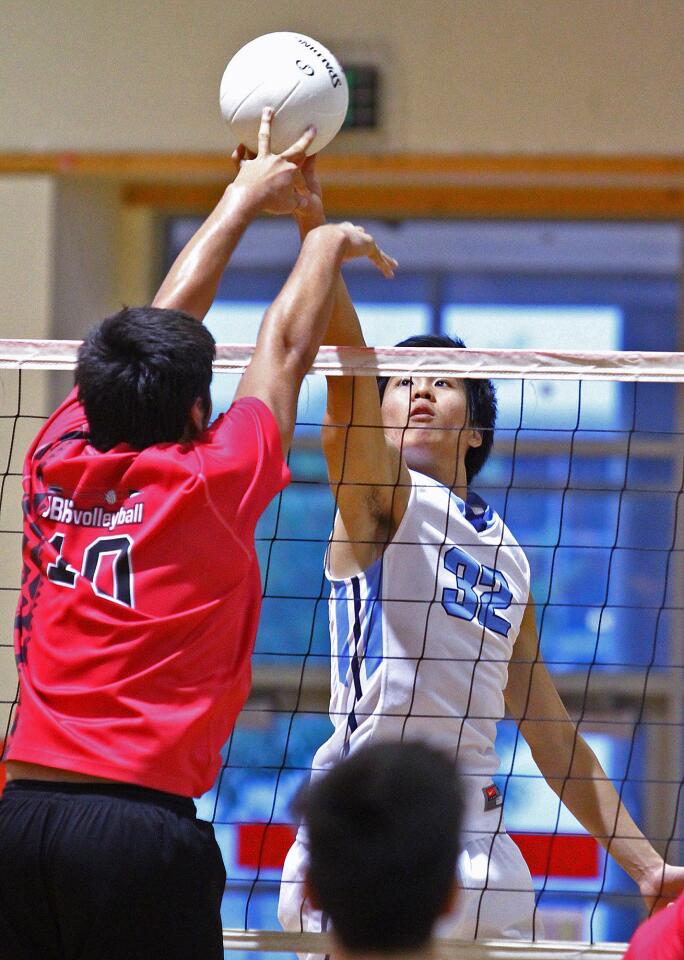 Crescenta Valley's Chris Yi and Burroughs' Tristan Martin battle at the net for the tip in a Pacific League boys volleyball match at Burroughs High School in Burbank on Thursday, May 1, 2014.