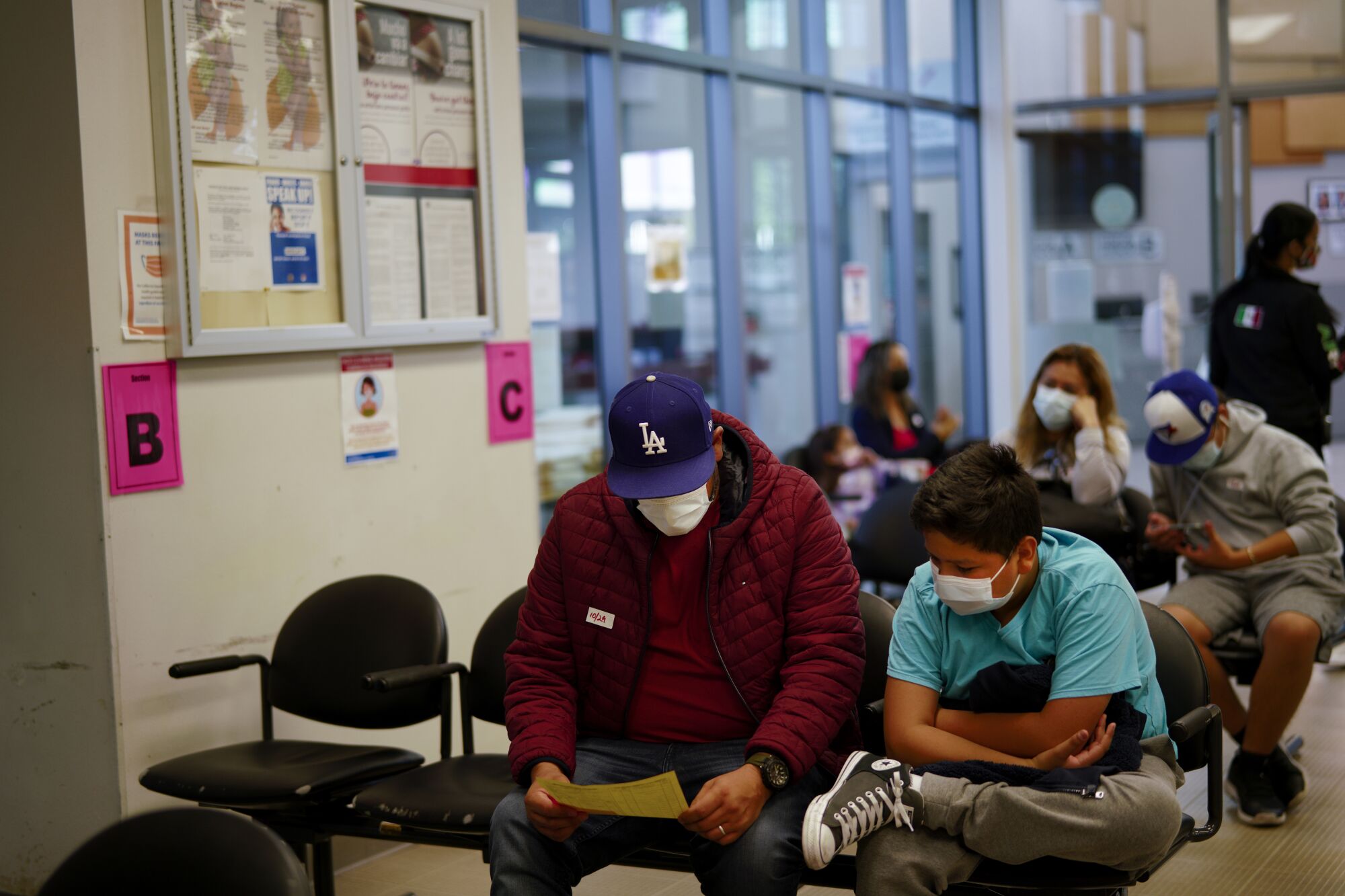 Julio Ibarra waited with his son, Julio Ibarra, Jr., to receive the flu vaccine.