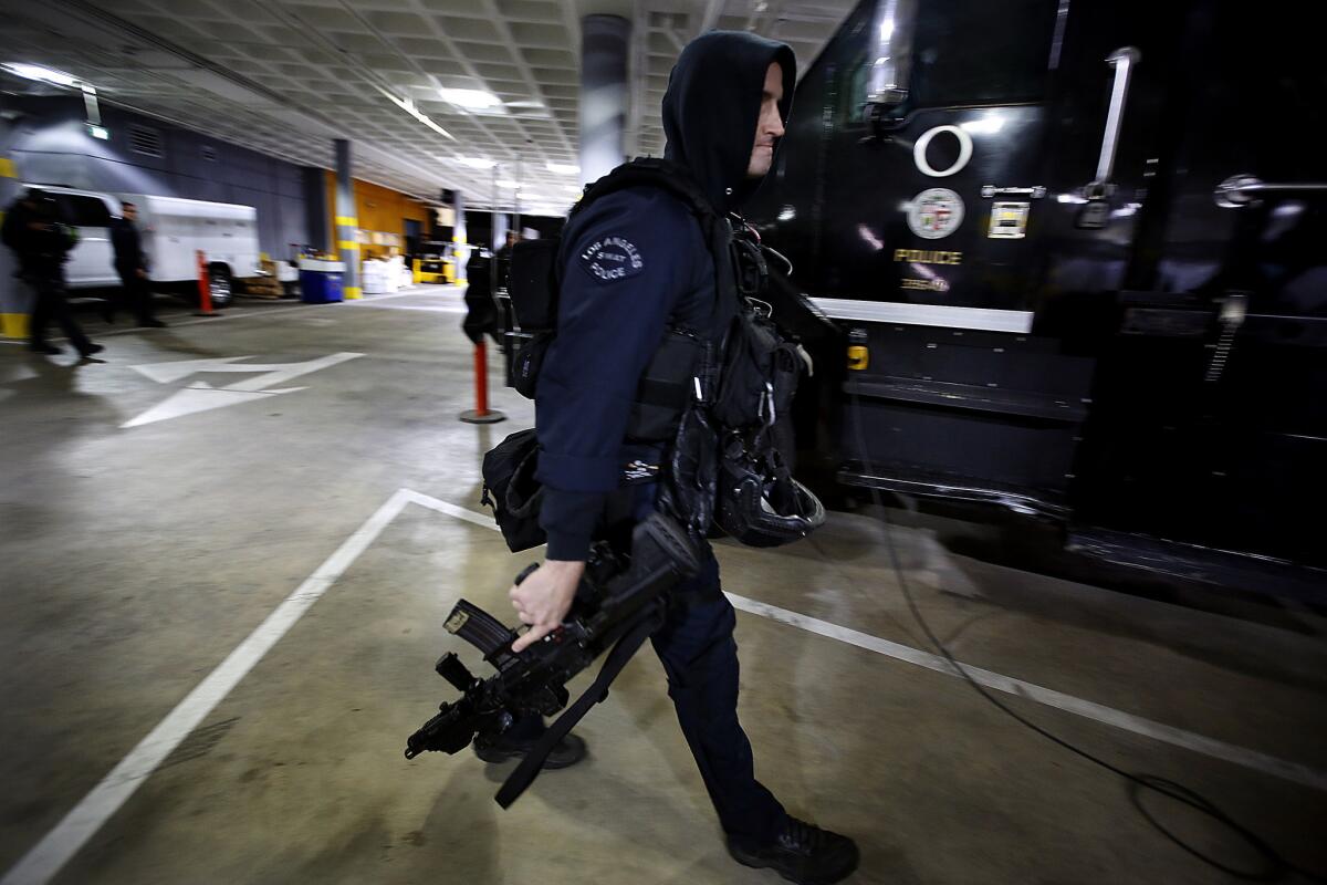 An LAPD SWAT officer prepares for a massive early-morning drug sweep.