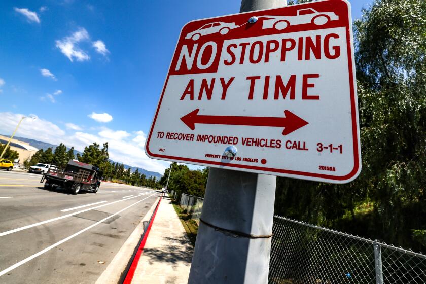Los Angeles, CA, Monday, April 15, 2024 - The curb along Forest Lawn Drive is freshly painted red after dozens of RV dwellers were removed from living on the side of the road.. (Robert Gauthier/Los Angeles Times)