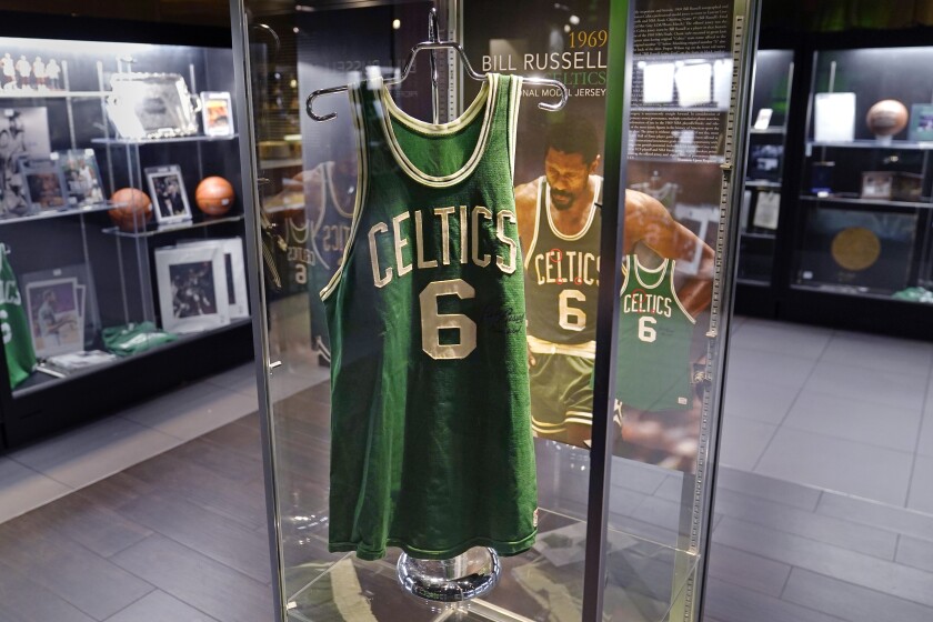 The 1969 game worn jersey of Boston Celtics' legend Bill Russell is displayed along with other memorabilia set to go up for auction, Thursday, Dec. 9, 2021, in Boston. Basketball fans hoping to buy something from Bill Russell's memorabilia collection should expect some big-name competition. Hall of Famers Shaquille O'Neal and Charles Barkley say they're interested in bidding on items that Russell is selling off. An online auction with 429 lots began last week and will culminate in a live event at the TD Garden on Friday, Dec. 10, 2021. (AP Photo/Charles Krupa)
