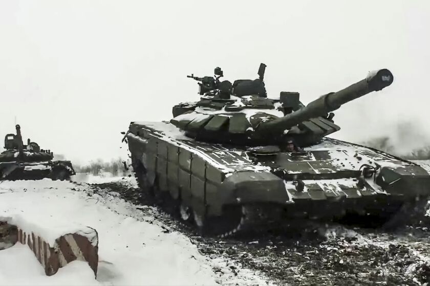 FILE - In this grab taken from video provided by the Russian Defense Ministry Press Service on Wednesday, Jan. 26, 2022, a Russian tanks roll during a military exercising at a training ground in Rostov region, Russia. The Kremlin, which has denied having any invasion plans, has scoffed at an argument that it wants to see the ground frozen to launch an attack on Ukraine. Ukrainian officials agree that the mud isn't an issue. (Russian Defense Ministry Press Service via AP, File)