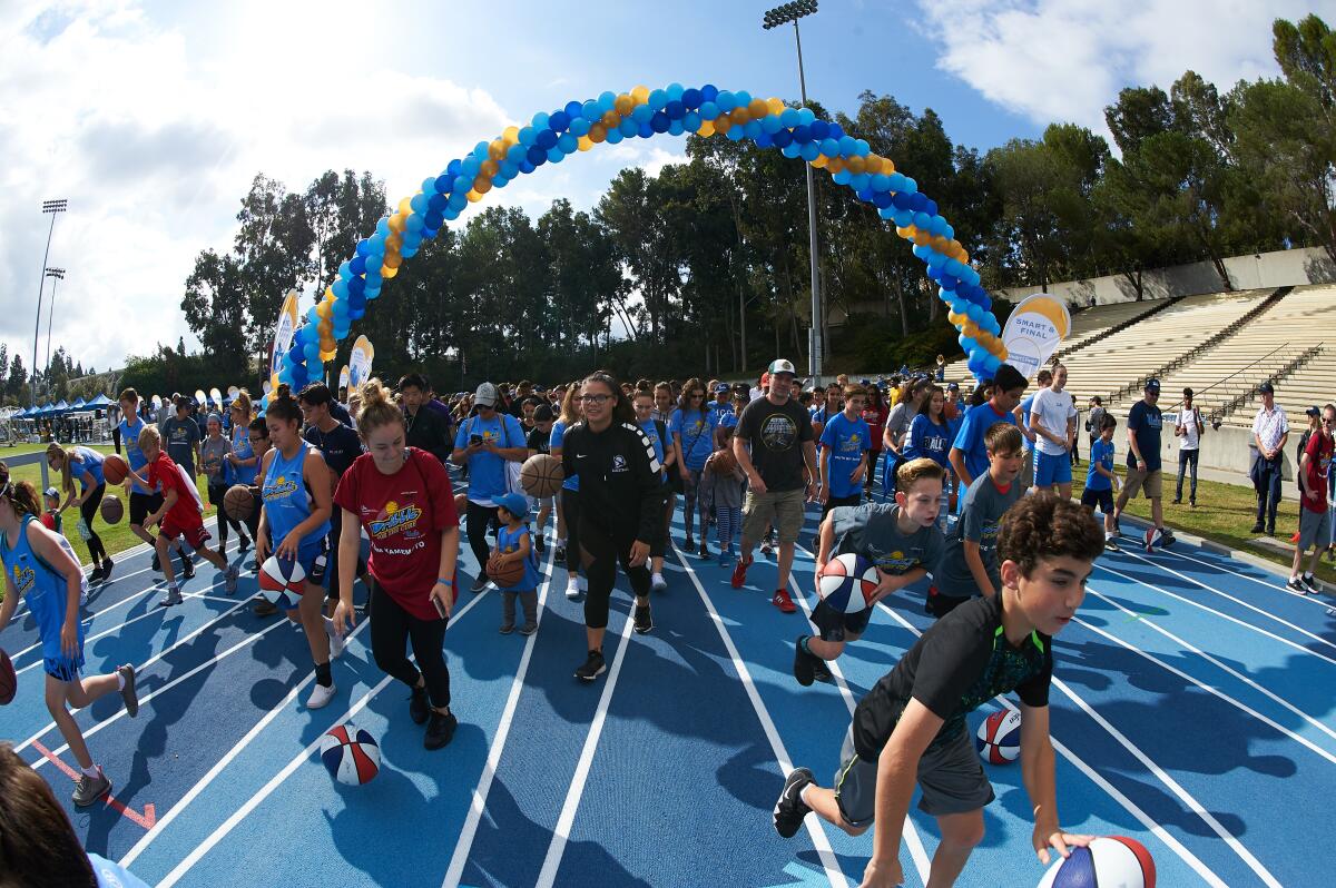 Children, their families and UCLA athletes take part in the 2018 Dribble for the Cure fundraiser.