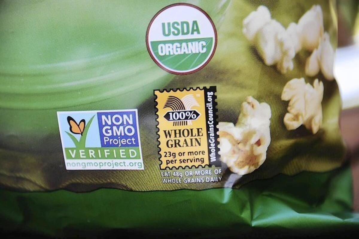 A label on a bag of popcorn shows it is a product with no genetically modified foods.