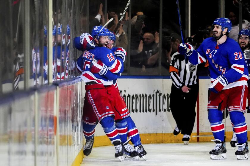 New York Rangers left wings Chris Kreider (20) and defenseman Adam Fox (23) react to center Vincent Trocheck's (16) game-winning goal in the second overtime in Game 2 of an NHL hockey Stanley Cup second-round playoff series against the Carolina Hurricanes, Tuesday, May 7, 2024, in New York. The Rangers won 4-3. (AP Photo/Julia Nikhinson)