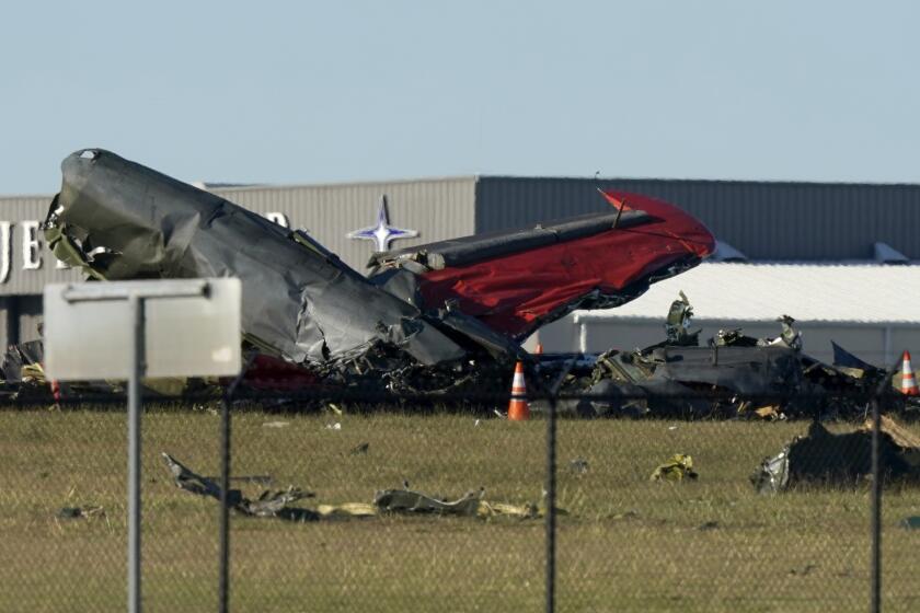 Debris from two planes after they collided during an airshow at Dallas Executive Airport on Saturday.