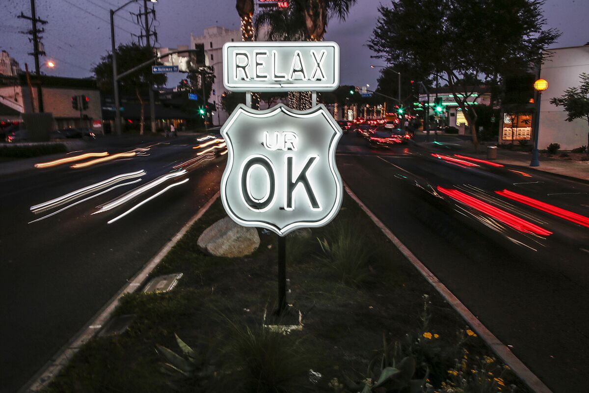 A sign in a median that says "relax ur OK"