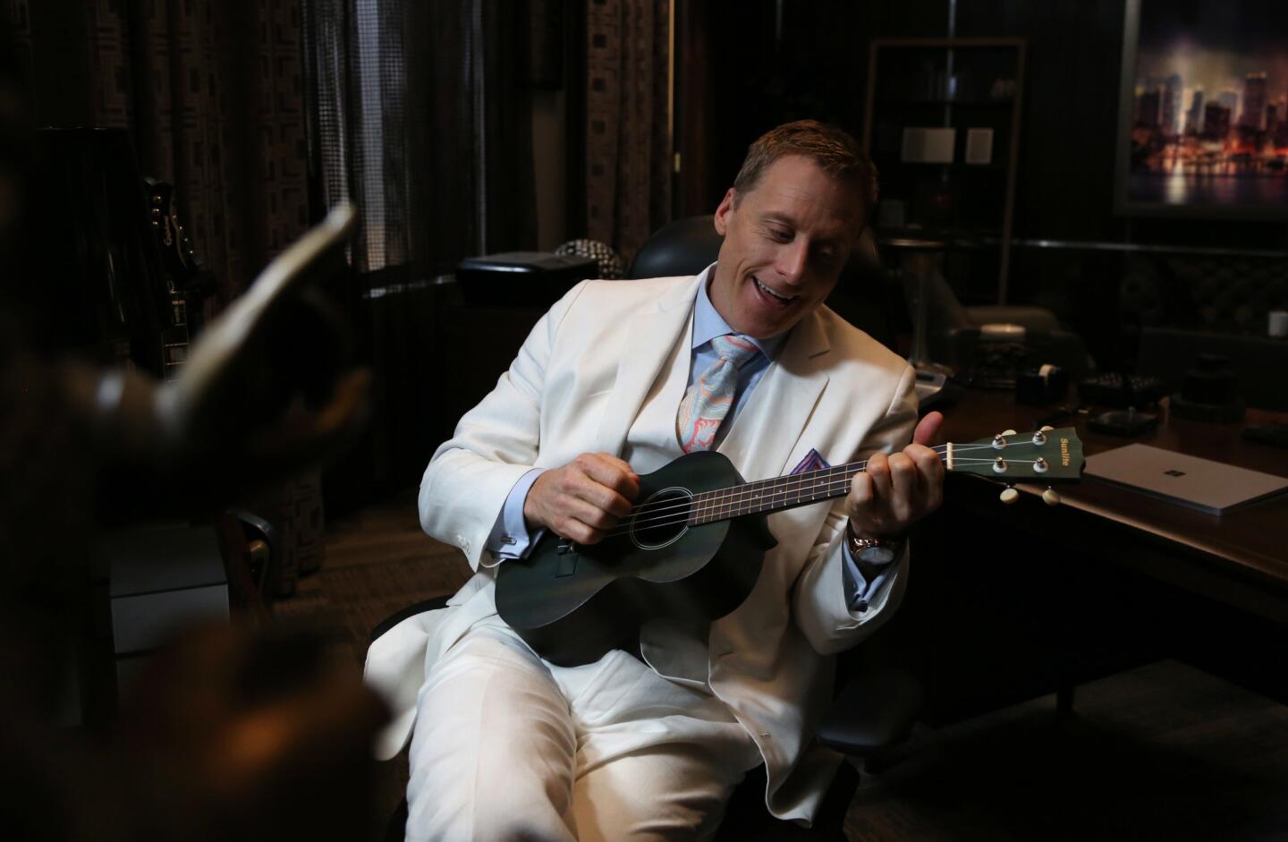 Actor Alan Tudyk, who plays Bruce Wayne's lesser-known cousin Van Wayne, strumbs the ukulele in his office set of the TV show 'Powerless,' filmed on the Warner Brothers studio lot.