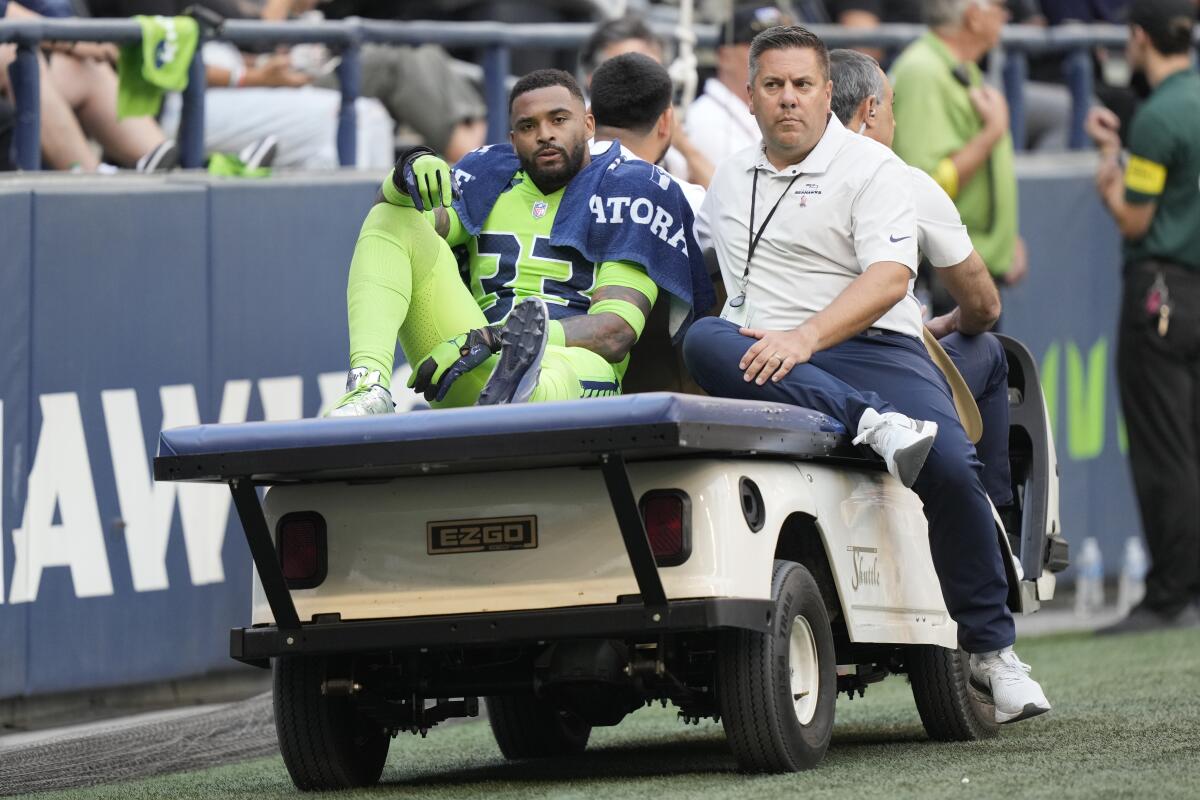 Seattle Seahawks safety Jamal Adams is taken off the field on a cart after an injury during the first half of an NFL football game against the Denver Broncos, Monday, Sept. 12, 2022, in Seattle. (AP Photo/Stephen Brashear)