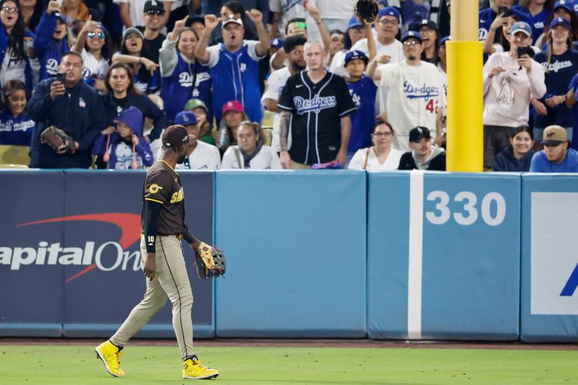 LOS ANGELES, CALIFORNIA - OCTOBER 06: Los Angeles Dodgers fans yell toward Jurickson Profar #10 of the San Diego Padres during the seventh inning in game two of the National League Division Series at Dodger Stadium on Sunday, Oct. 6, 2024 in Los Angeles. (Gina Ferazzi / Los Angeles Times)