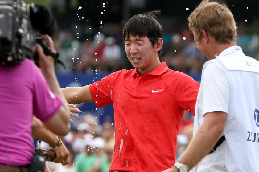 Seung-Yul Noh celebrates with fellow golfers Charlie Wi and Y.E. Yang (not pictured) and his caddie Scott Saitinac after winning the Zurich Classic on Sunday at TPC Louisiana.