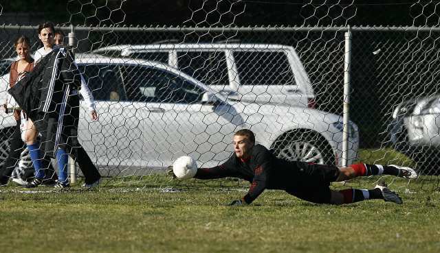 Corona del Mar's Connor Gaal stretches out to save a goal during a CIF Southern Section Division III second-round playoff game against Santa Ana Valley.