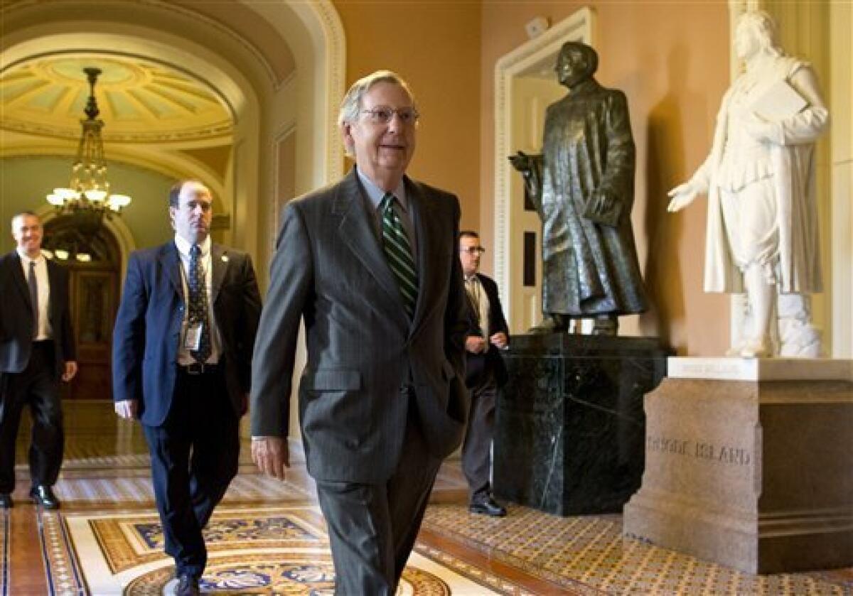 Senate Minority Leader Sen. Mitch McConnell (R-Ky.) walks to his office as intense negotiations continued with Majority Leader Harry Reid (D-Nev.).