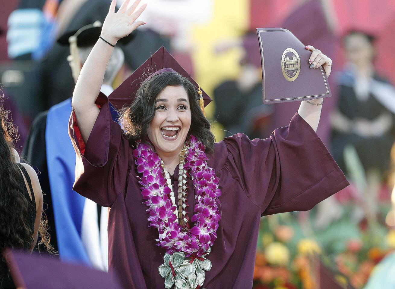 Nancy Diaz, of Arleta, who plans to attend Cal State University Northridge in the fall, waves to family at the 2019 commencement ceremony at Glendale Community College in Glendale on Wednesday, June 12, 2019.