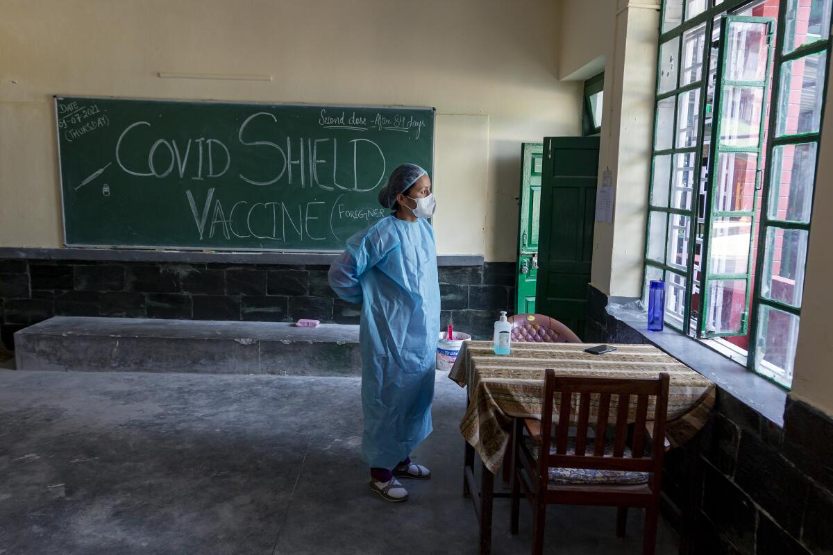 Nurse putting on protective suit in Dharmsala, India