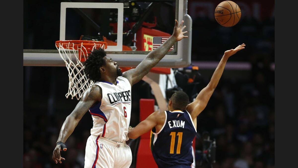 Utah Jazz center Dante Exum floats a shot over Clippers center DeAndre Jordan in second half of Sunday's game.