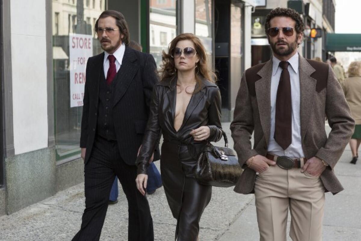 Christian Bale, left, Amy Adams and Bradley Cooper in "American Hustle."