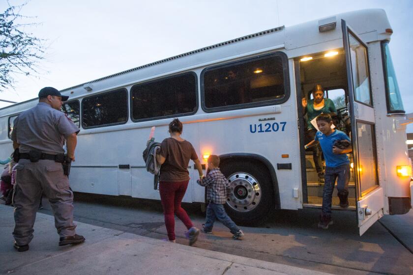 FILE - In this May 28, 2014, file photo, migrants are released from ICE custody at a Greyhound bus station in Phoenix. A Customs and Border Protection memo dated Jan. 28, 2020, obtained by The Associated Press confirms that bus companies such as Greyhound do not have to allow Border Patrol agents on board to conduct routine checks for illegal immigrants, despite the company's insistence that it has no choice but to do so. (Michael Chow/The Arizona Republic via AP, File)