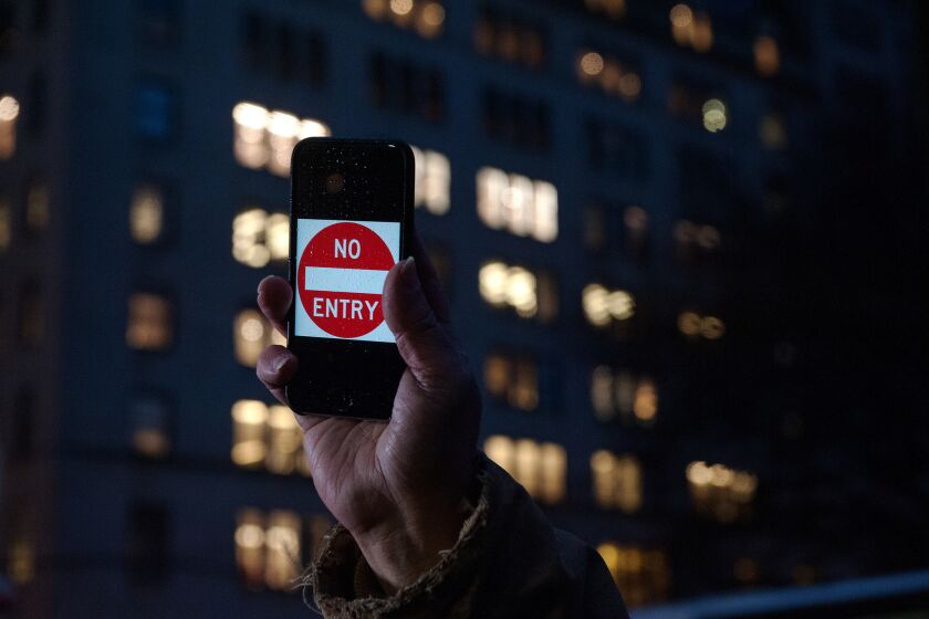 A demonstrator outside of the the Apple store in New York City last month expresses support for the company's refusal to give authorities a backdoor into devices.