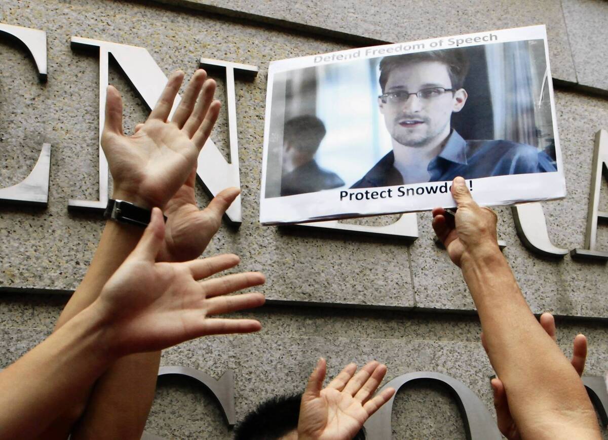 A supporter holds a picture of Edward Snowden outside the U.S. Consulate General in Hong Kong on June 13.