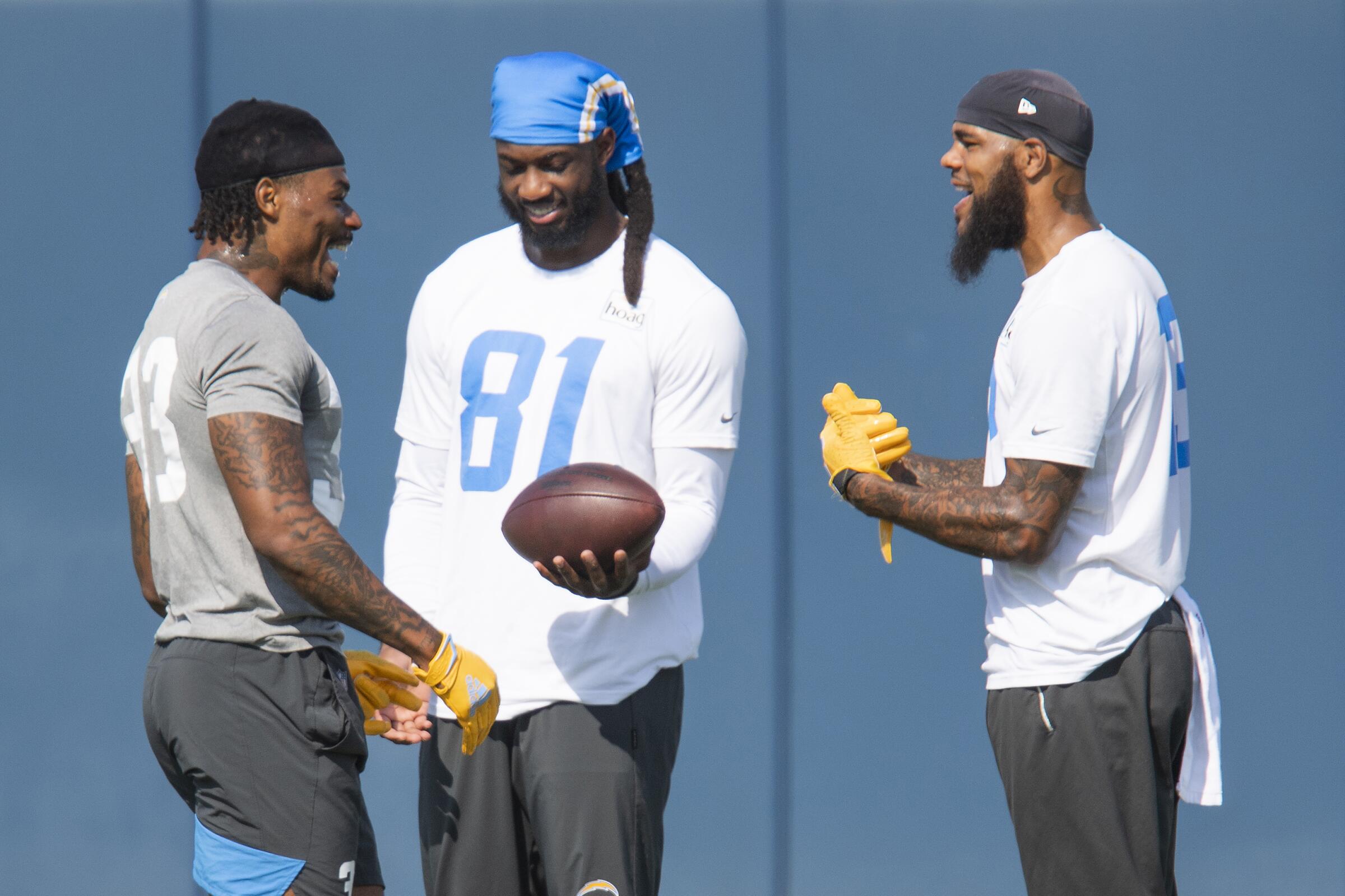 Chargers safety Derwin James, left, talks with receivers Mike Williams (81) and Keenan Allen.
