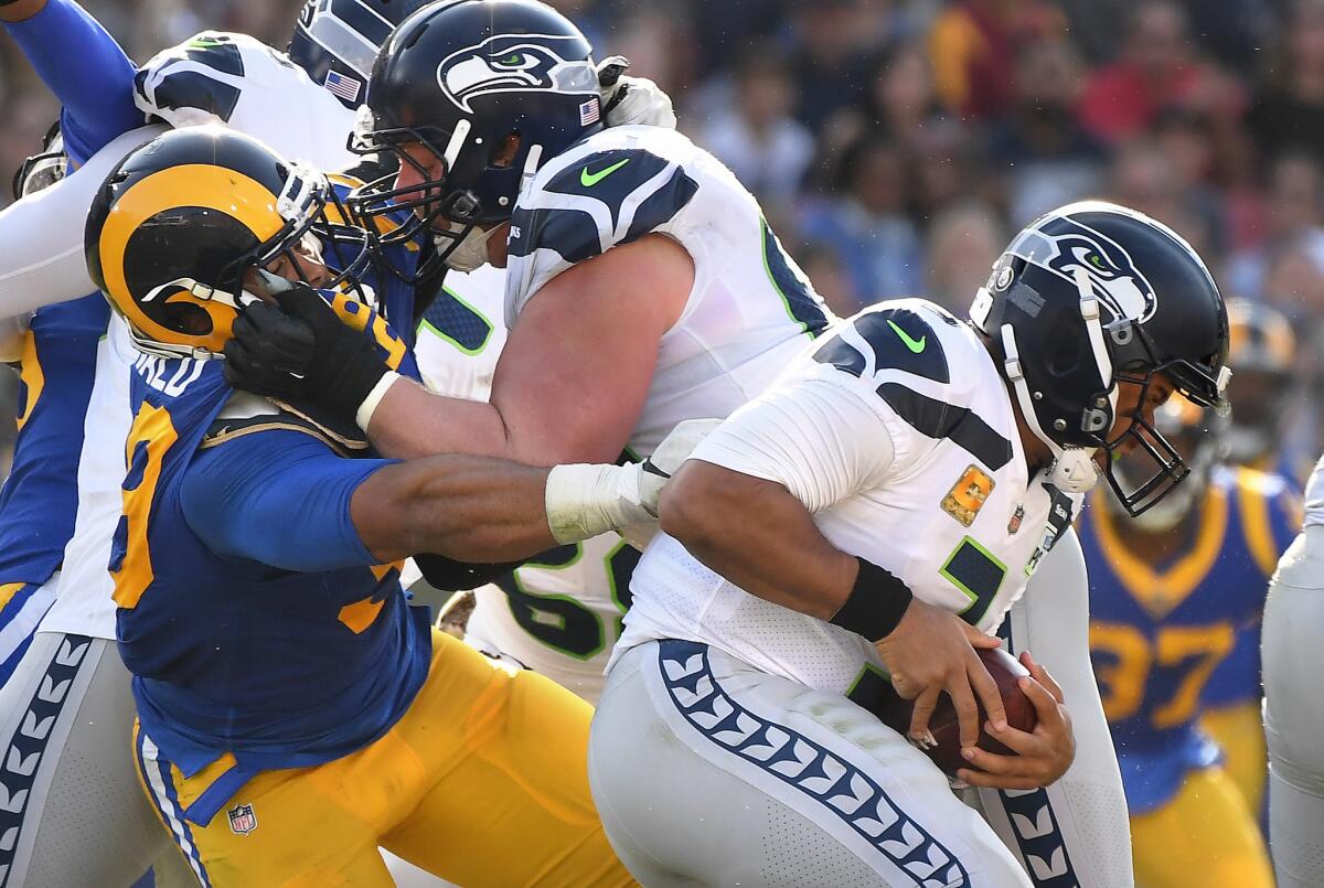Rams defensive tackle Aaron Donald sacks Seattle Seahawks quarterback Russell Wilson during the teams' Nov. 11 game at the Coliseum. The Rams beat the Seahawks in both games this season.