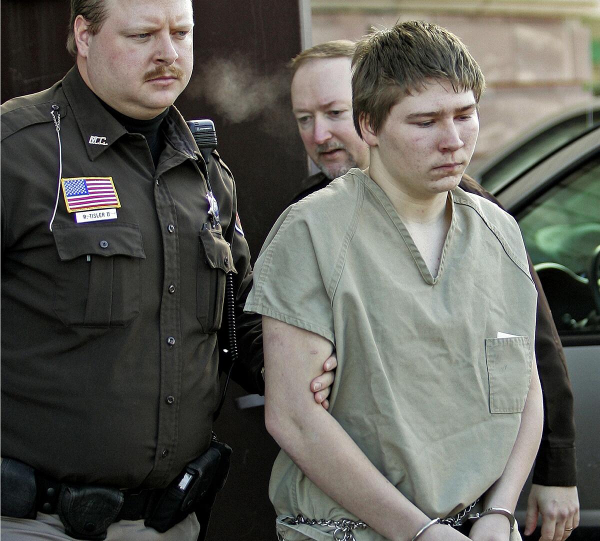 In this March 3, 2006, photo, Brendan Dassey is escorted out of a Manitowoc County courtroom in Manitowoc, Wis.